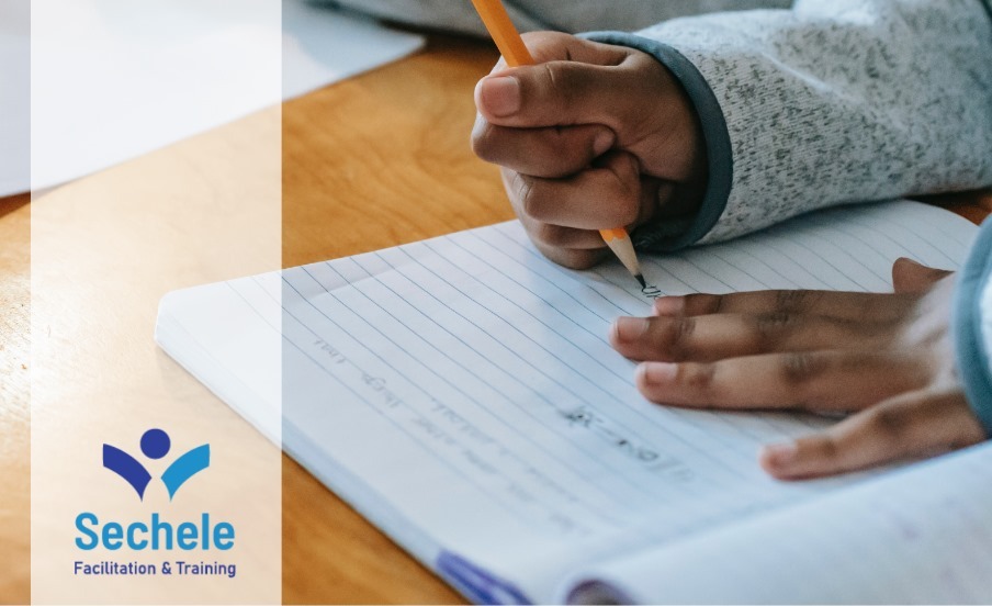 Student receiving academic mentoring from Sechele